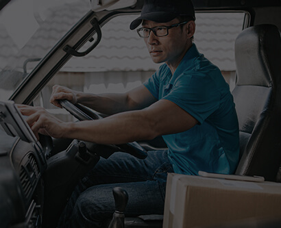 A man sitting in a truck cabin.