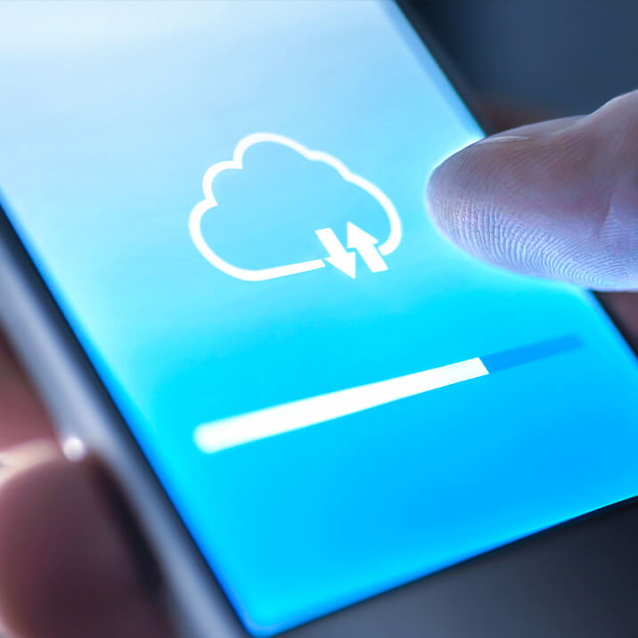 A man is using the cloud on his smartphone to download data.